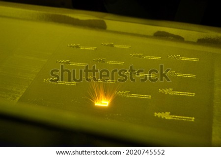3D printer prints object from metal powder. Metal is sintered under laser