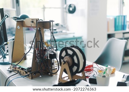 3D printer and tools on the laboratory desk: additive manufacturing, prototyping and engineering concept