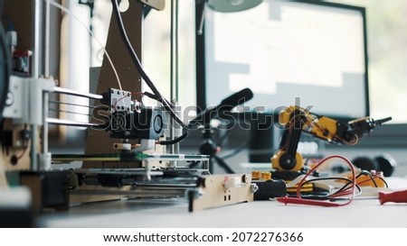 3D printer and tools on the laboratory desk: additive manufacturing, prototyping and engineering concept
