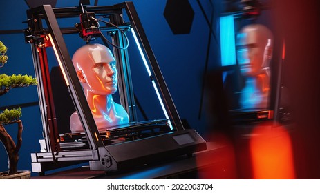 3D printer at work. 3d printer prints head, advertising photo blue and orange light. High quality photo