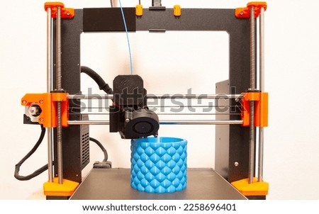 3D printer working with blue filament 