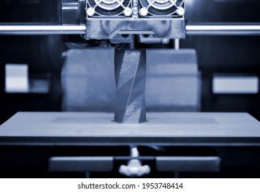 3D printer works and creates an object from the hot molten plastic