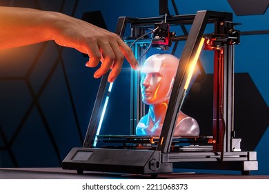 3D printing in progress. 3d printer printed a hand. A man touches the product printed on a 3d printer. God's touch, biblical motives. High quality photo