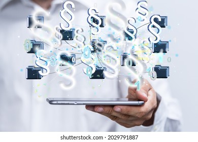 A 3D render of floating paragraph law and justice symbols over a hand holding a phone