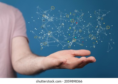 A 3D rendered abstract network hovering over a man's palm against a blue background