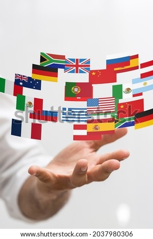 A 3D rendered stickers of different countries hovering over a person's hand
