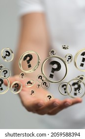 A 3D rendering of black question marks floating on a man's hand