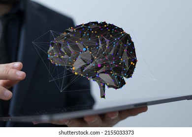 A 3D rendering of digital brain in front of a male holding tablet- concept for creative brain network and digital IQ