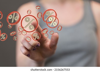 A 3d rendering of a female pointing into hologram of percentage icons- interest rates concept