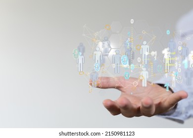 A 3D rendering of human icons with binary codes over a hand-social network communication concept - Powered by Shutterstock - Get 15% off with code: PIKWIZARD15