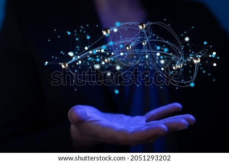 A 3d rendering of molecules abstraction hovering over a man's palm in blue light - science and unity concept