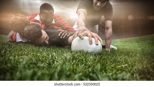 3D Rugby stadium against rugby players tackling during game - Powered by Shutterstock