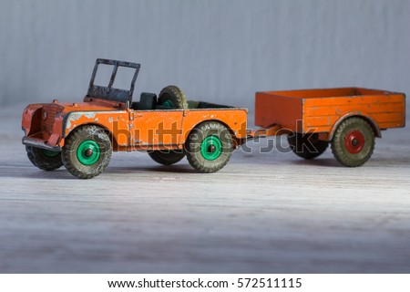 3d small retro model of car Land Rover, used, heavy, toy of metal in orange.