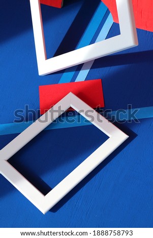 3d still life: white rectangular frames, red and blue shapes on blue background. Abstract art design, cobalt contrast composition. Financial, economic, banking, political indicators