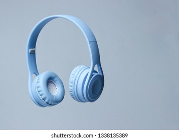 3D surround photo blue wireless headphones on gray background.