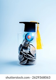 3d Target icon inside light bulb wearing graduation hat, on many coins in glass jar on blue background, vertical style. Savings money for education, knowledge course and learning, scholarship concept.