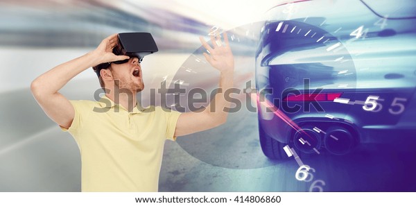 3d technology, virtual reality, entertainment\
and people concept - young man with virtual reality headset or 3d\
glasses playing game playing car racing game over tachometer and\
street race background