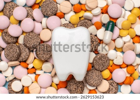 3D Tooth Model Surrounded by Colorful Pills and Capsules in Medical Concept