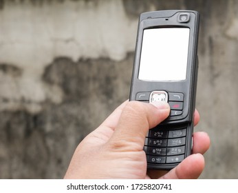 3g slider phone on hand. vintage mobile phone with rear camera and blank screen. - Shutterstock ID 1725820741