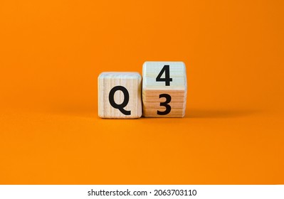 From 3rd To 4th Quarter Symbol. Turned A Wooden Cube And Changed Words 'Q3' To 'Q4'. Beautiful Orange Table, Orange Background. Business, Happy 4th Quarter Q4 Concept, Copy Space.