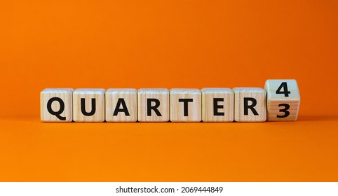 From 3rd to 4th quarter symbol. Turned a wooden cube and changed words 'quarter 3' to 'quarter 4'. Beautiful orange table, orange background. Business, happy 4th quarter concept, copy space.