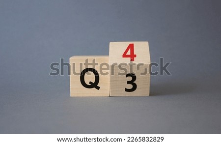 From 3rd Quarter to 4th symbol. Turned wooden cubes with words 3rd Quarter and 4th Quarter. Beautiful grey background. Business and Quarter concept. Copy space