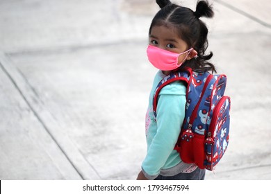 3-year-old Latina girl with covid-19 protection mask and backpack for back to school, new normal
