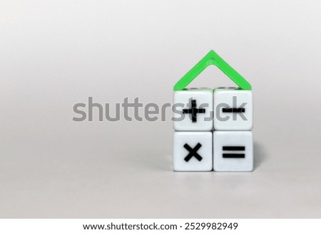 4 cubes with math symbols and a triangular roof. The concept of a mortgage.
