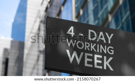 4 - Day working week on a black city-center sign in front of a modern office building	