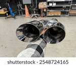 4 inch Dual Chrome Stainless Steel Exhaust Tip inside a shop