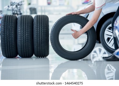 4 new tires that change tires in the auto repair service center, blurred background, the background is a new car in the stock blur for the industry, a four-wheeled tire set at a large warehouse - Shutterstock ID 1464540275