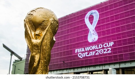 4 September 2019, Moscow, Russia. Copy of world cup trophy on background logo of the FIFA world Cup 2022, which will be held in Qatar, on a giant screen in the city center.