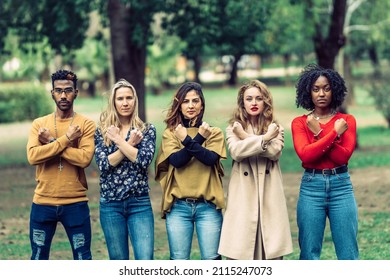 4 Women And A Man With Arms Crossed And Fists Clenched As A Symbol Of Resistance To Machismo