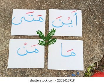 4 Words Written In Arabic In Blue And Diacritics In Red. In The Form Of Cards. Meaning: Where? When? Who Is He ? What?