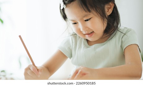4 year old Asian child studying
