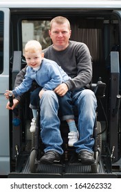 4 Year Old Boy And 35 Year Old Disabled Men On Wheelchair Lift