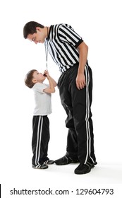 A 4 Year Old Boy Blowing Teen Referee's Whistle Isolated On A White Background