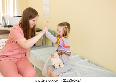 4 Year Old Patient Joyfully High Fives To The Female Doctor