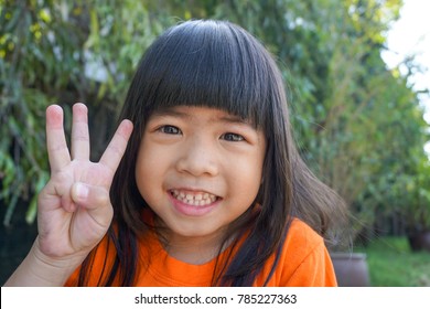 4 Years Old Asian Cute Girl Counting Number Three By Fingers. Education Or Toddler Development Concept. Happy Learning.