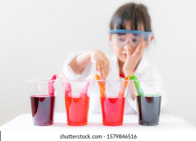 A 4 Years Old Asian Little Girl Is Learning About Color Changing Walking Water Experimental, Concept Of Kid Education For Fundamental Science Learning Activity.