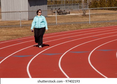 40 Year Old Overweight Woman Walking Around The High School Track