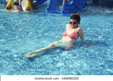 40 Years Old Woman In The Pool. Happy Woman Enjoy In The Swimming Pool