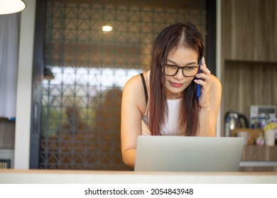 40 Years Old Woman Use Phone And Computer Work At Home.