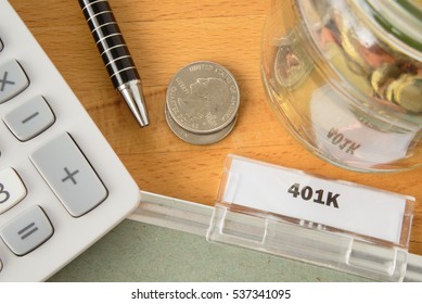 401k File With Calculator, Pen, Coins And Glass Jar