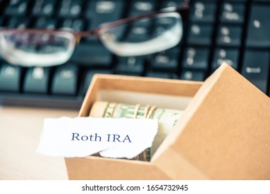 401k Ira Roth On Pieces Of Colorful Paper Dollars On Table. Pension Concept. Retirement Plans.