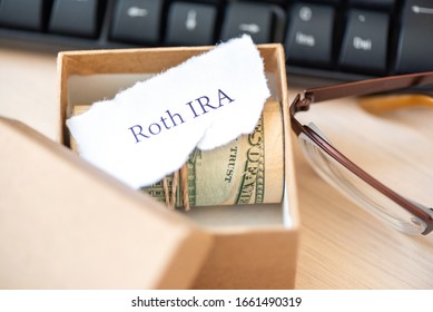 401k Ira Roth On Pieces Of Colorful Paper Dollars On Table. Pension Concept. Retirement Plans.