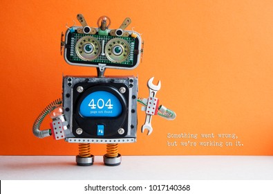 404 error page not found. Serviceman robot hand wrench pliers on orange background. Text message Something went wrong but we are working on it