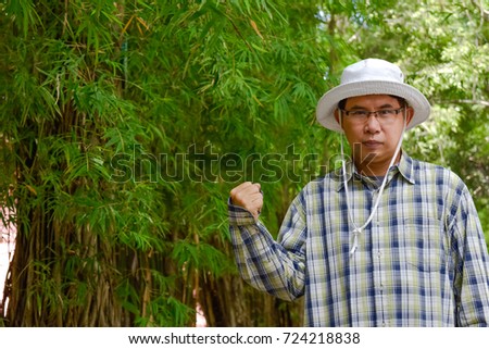 Similar – Portrait of a young man in the bamboo jungle