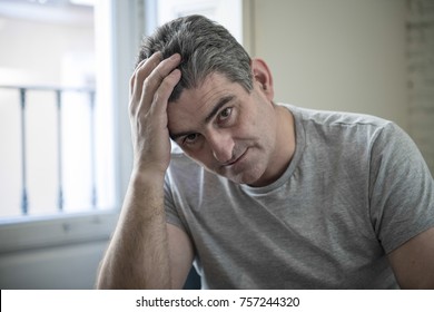 40s Or 50s Sad And Worried Man With Grey Hair Sitting At Home Couch Looking Depressed And Wasted In Sadness Face Expression In Depression And Life Problems Concept