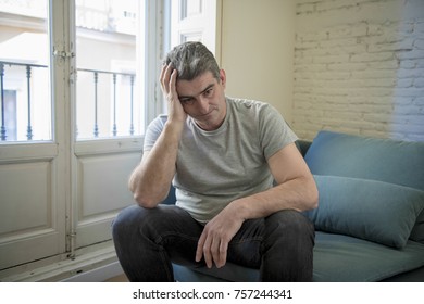 40s Or 50s Sad And Worried Man With Grey Hair Sitting At Home Couch Looking Depressed And Wasted In Sadness Face Expression In Depression And Life Problems Concept